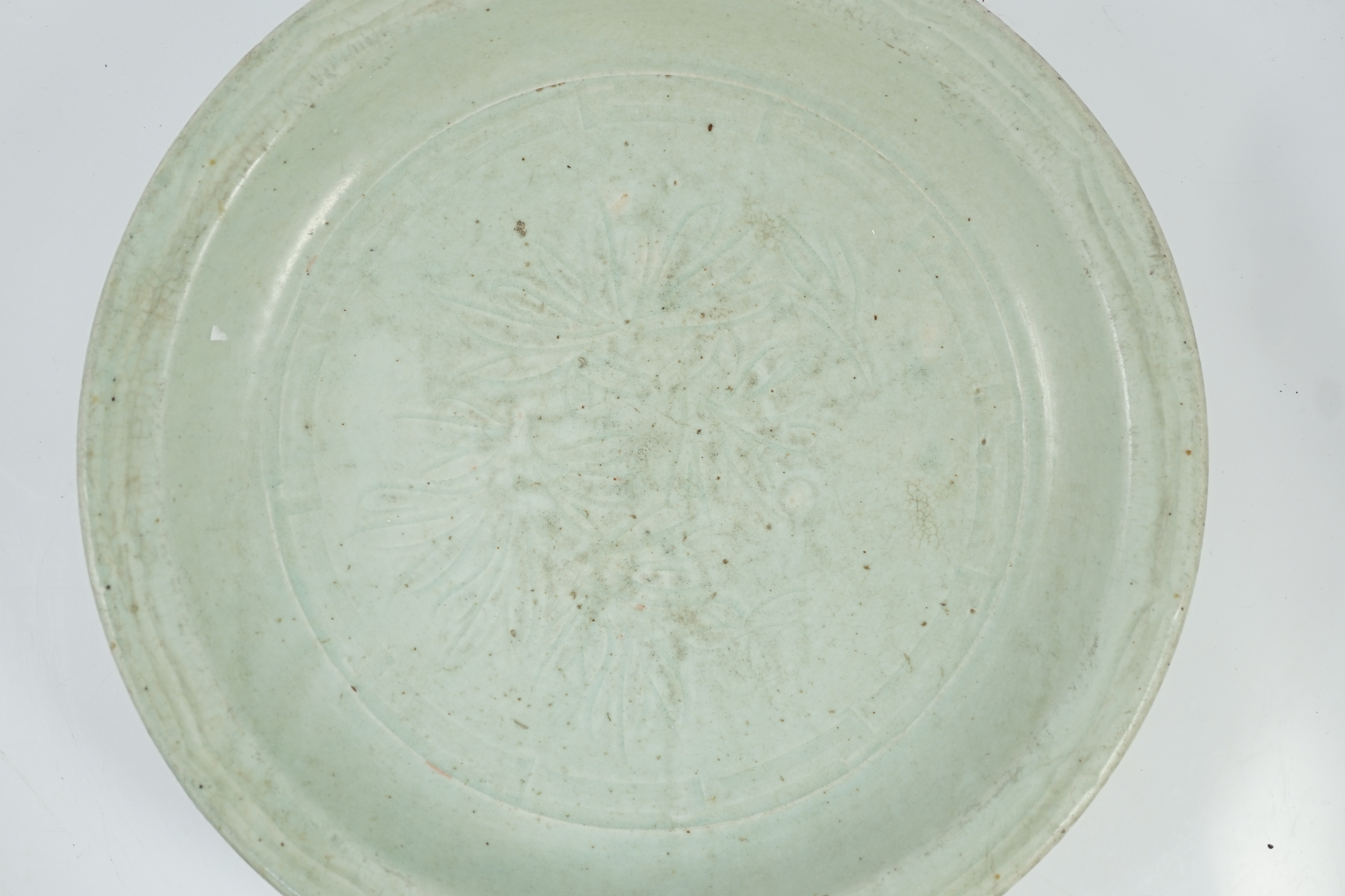 A Chinese Longquan celadon dish, Yuan-Ming dynasty, 13th/14th century, some faults